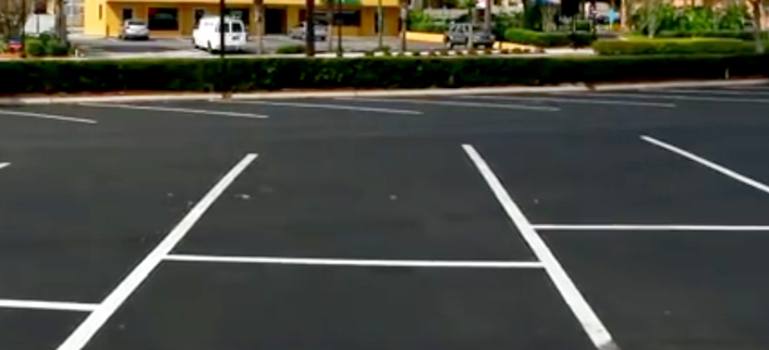 sealcoating in Orlando - newly sealcoated and striped lot